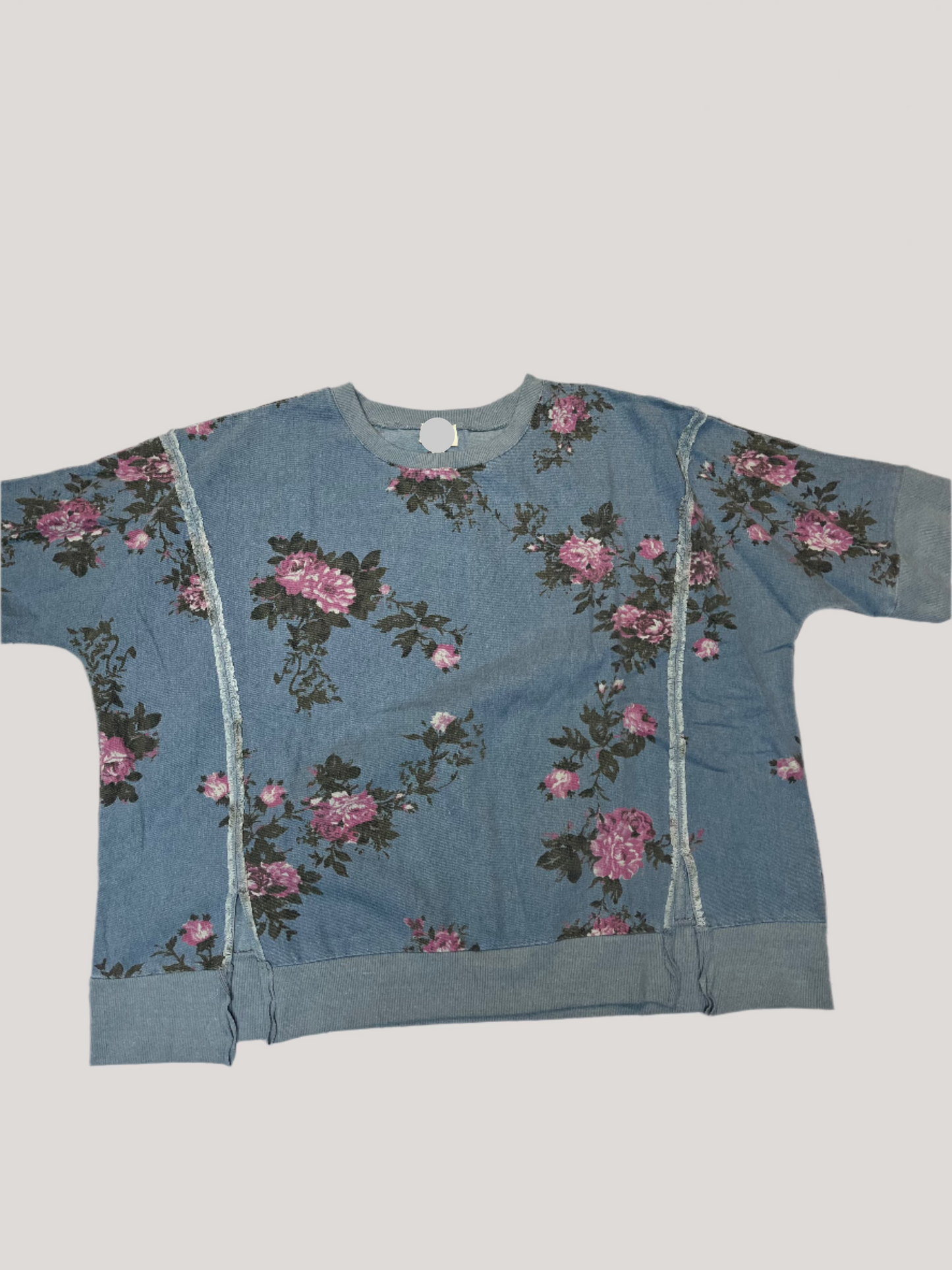 Blue tank top with floral pattern on a textured surface
